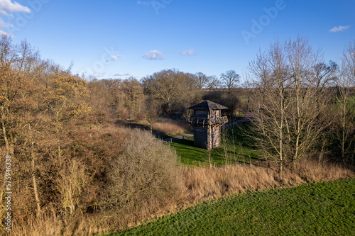 Aerial view of preserved wooden Roman watch tower on archaeological site castellum Fectio in Dutch landscape with barren trees surrounding the historic observatory and defensive structure photo