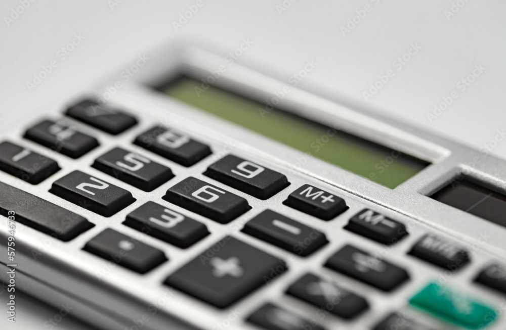 Calculator, silver device for financial calculations, side view, close-up selective focus Calculator, silver device for financial calculations, side view, close-up selective focus