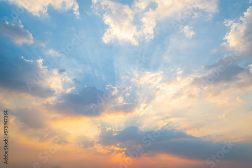 sunset or sun rise sky with rays of yellow and red light shining clouds and sky background and texture