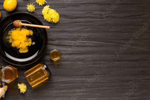 Different types of honey on a dark wooden background top view copy space.