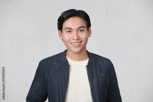 normal young man standing on a white background