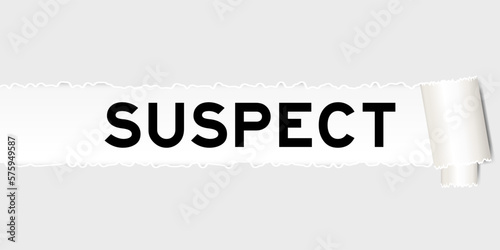 Ripped gray paper background that have word suspect under torn part