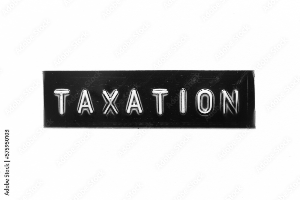 Black color banner that have embossed letter with word taxation on white paper background