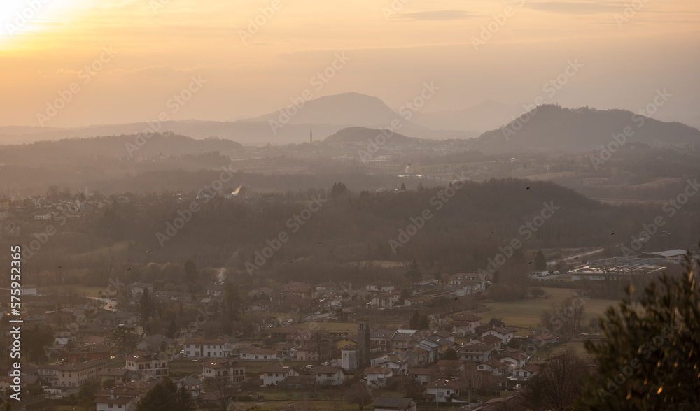 Panorama of the city and mountains in the fog from above. during the sunset