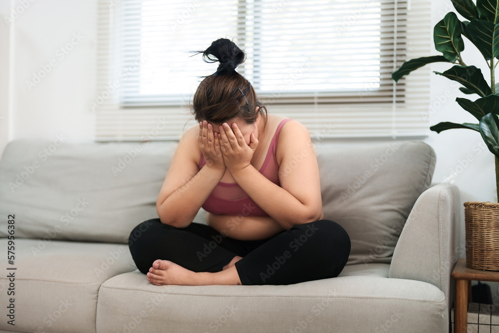 overweight woman sitting on the sofa stress about loss weight.. overweight woman sitting on the sofa stress about loss weight..