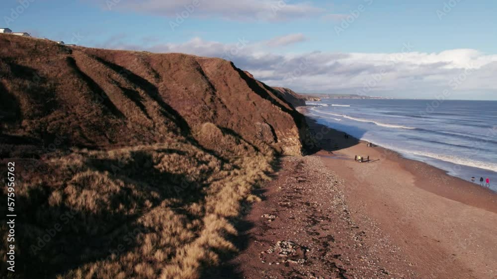 Drone flies sideways over beach and cliffs on the spectacular County Durham coast. Shot on a winter day. Drone flies sideways over beach and cliffs on the spectacular County Durham coast. Shot on a winter day.