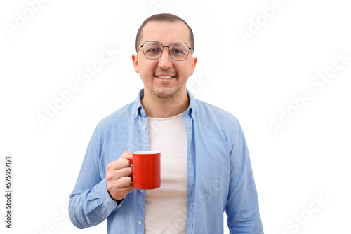 Portrait of a confident business man with a cup in his hands looks at the camera on a white background photo