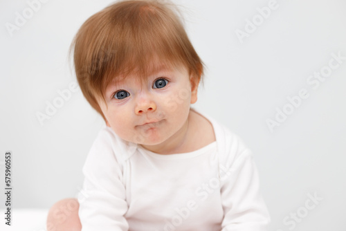Portrait of cute happy six month baby girl. Childhood and baby care concept