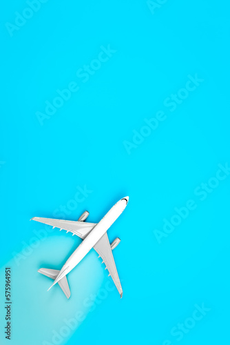 White plane, airplane on a blue background, flat lay, copy space.