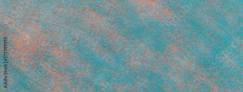 Texture of a light blue felt background with coral spots of fabric, macro. Structure of woolen turquoise textile