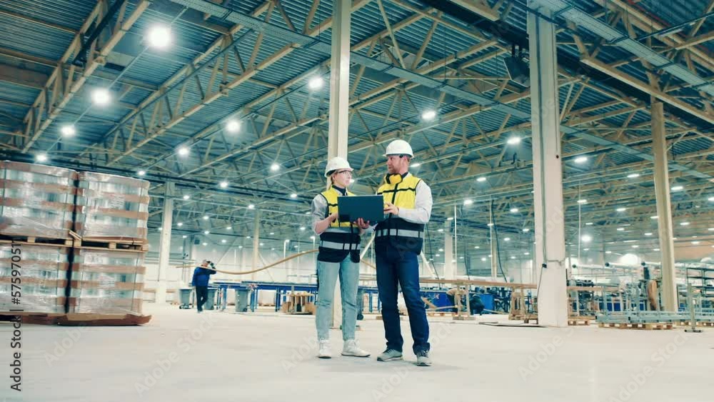 Fiberglass factory with two engineers observing the premises Fiberglass factory with two engineers observing the premises