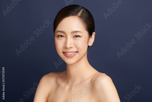 Beautiful young asian woman with clean fresh skin on blue background, Face care, Facial treatment, Cosmetology, beauty and spa, Asian women portrait.