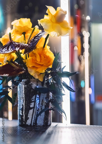 Roses in Vase with colourful lights background.