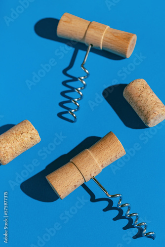 Wallpaper Mural Creative composition made of corkscrews and wine bottle corks on blue background with shadow at sunlight. Party drink concept. Minimal style Torontodigital.ca