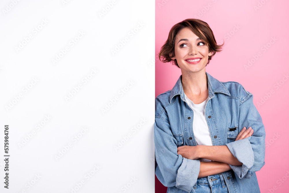 Photo of cute cheerful girl crossed arms look empty space billboard isolated on pink color background Photo of cute cheerful girl crossed arms look empty space billboard isolated on pink color background