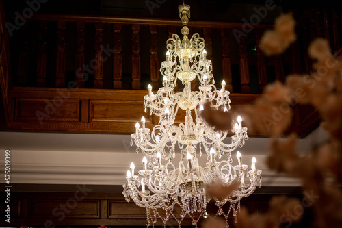 crystal chandelier in a wooden banquet hall