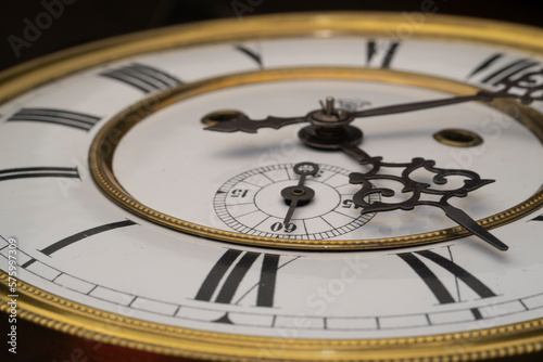 Vintage Clock with Hands. Close up view on clock face of a historical watches with golden frame