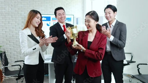 young asian business woman and team receiving a trophy, business success, group of people working together