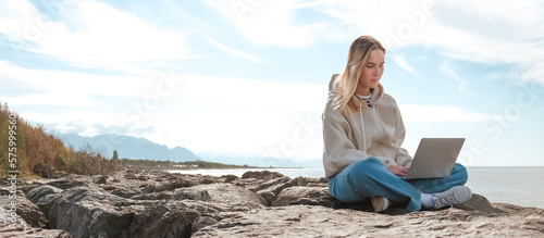Remote work.Girl freelancer works remotely on the sea shore. workation, remote work,WFVH,Van Life vibes work from vacation home,work travel,remotely work.Travelling.Work from vacation remotely