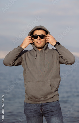 Handsome young man walking by sea. Sports, active lifestyle concept.