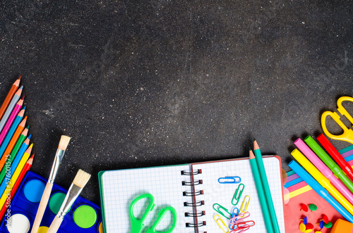 School supplies on dark table