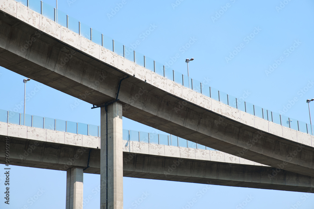 Elevated expressway during a sunny day . highway overpass against blue sky . Motorway viaduct interchange Elevated expressway during a sunny day . highway overpass against blue sky . Motorway viaduct interchange