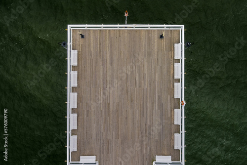 wooden pier on the background of green water