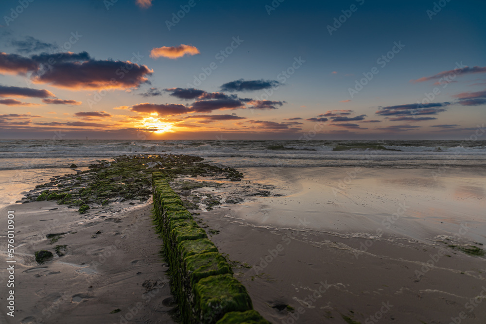 Wooden breakwater, sunset at the Baltic Sea, Sylt, Germany