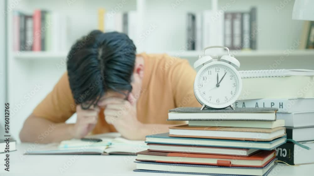 Asian student man have anxiety because of exams, male prepare for test and learning lessons in the library. stress, despair, haste, misunderstanding reading, discouraged, expectation, knowledge, tired Asian student man have anxiety because of exams, male prepare for test and learning lessons in the library. stress, despair, haste, misunderstanding reading, discouraged, expectation, knowledge, tired
