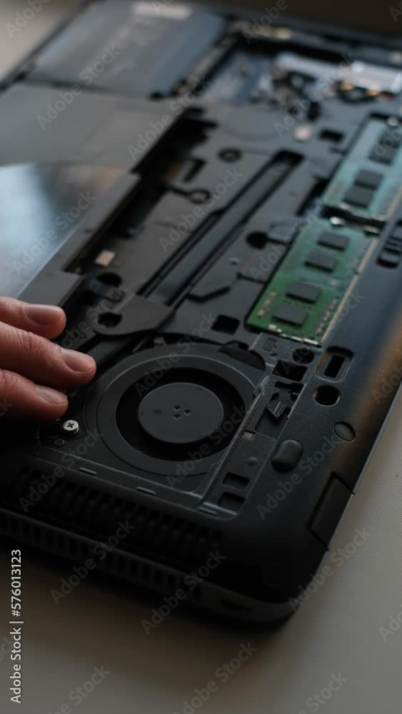 repair technician cleaning from dirt and dust inside the laptop close-up repair technician cleaning from dirt and dust inside the laptop close-up