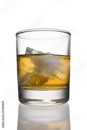 Cocktail whiskey with ice and lime in a low glass with reflection close up