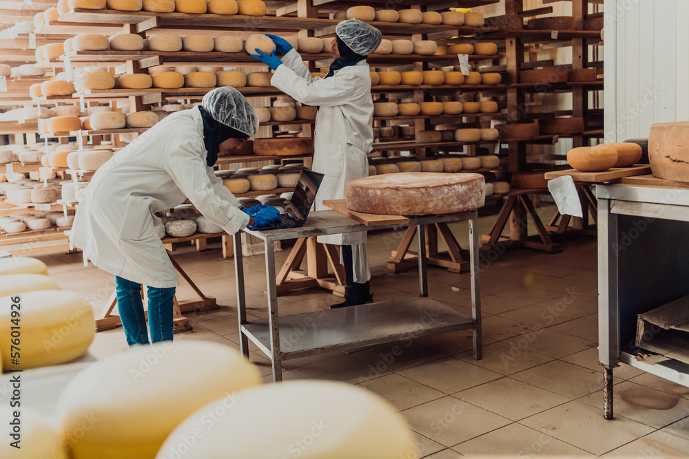 Muslim business partners checking the quality of cheese in the modern industry Muslim business partners checking the quality of cheese in the modern industry