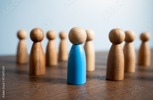 Blue men standing among the crowd. Hiring by competition among candidates. Different from others. Comes out. Leader and guide. Society and individuals. Talented worker. photo