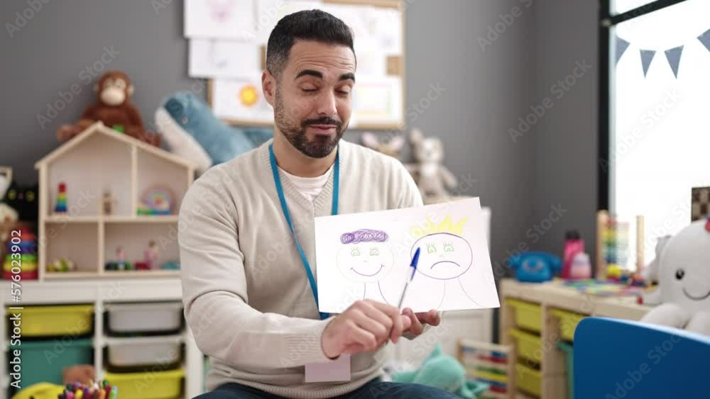 Young hispanic man working as teacher having emotion therapy at kindergarten