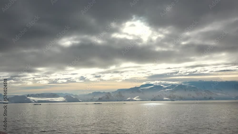 Ocean. Colorful waters of the ocean. View of a landscape of a ocean with a snowy mountain and rocks. Travel. Ocean. Colorful waters of the ocean. View of a landscape of a ocean with a snowy mountain and rocks. Travel.
