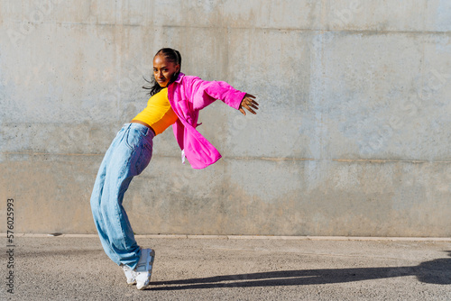 Dancer on tip toe in front of wall