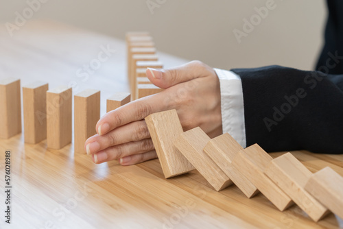 Obraz na plátně Protection finance, stopping falling block effect collapse domino wooden, Recovery risk business, Management strategy and planning before destroy
