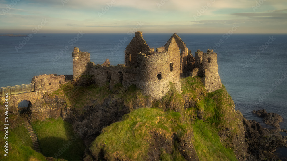 Front view of Dunluce Castle located on the edge of cliff, part of Wild Atlantic Way, Bushmills, Northern Ireland. Filming location of popular TV show Game of Thrones