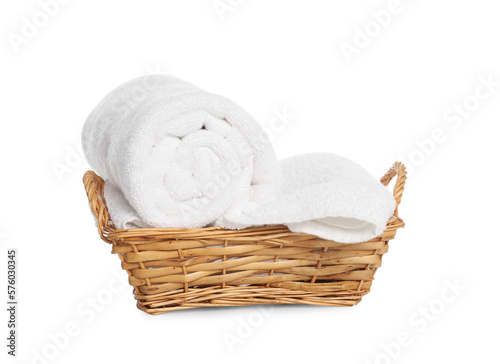 Wicker basket with rolled bath towels isolated on white