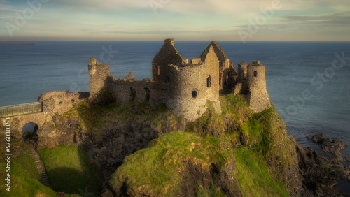 Front view of Dunluce Castle located on the edge of cliff, part of Wild Atlantic Way, Bushmills, Northern Ireland. Filming location of popular TV show Game of Thrones photo