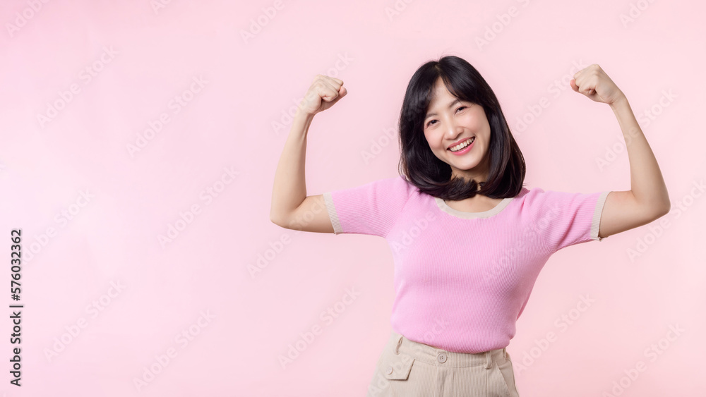 Portrait young asian woman proud and confident showing strong muscle strength arms flexed posing, feels about her success achievement. Women empowerment, equality, healthy strength and courage concept Portrait young asian woman proud and confident showing strong muscle strength arms flexed posing, feels about her success achievement. Women empowerment, equality, healthy strength and courage concept
