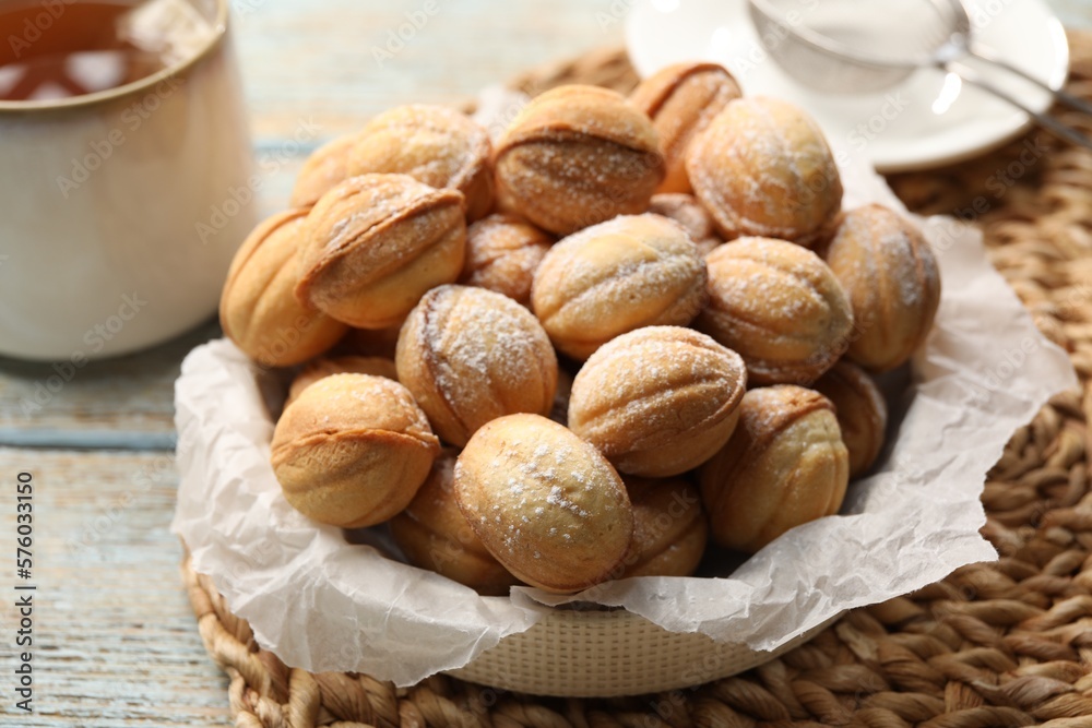 Bowl of delicious nut shaped cookies on grey wooden table