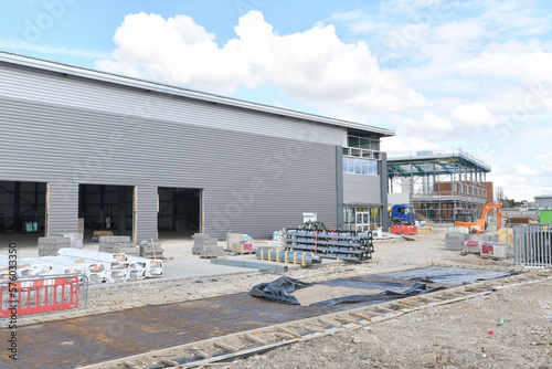 construction site of commercial warehouse building showing various materials and frame of building