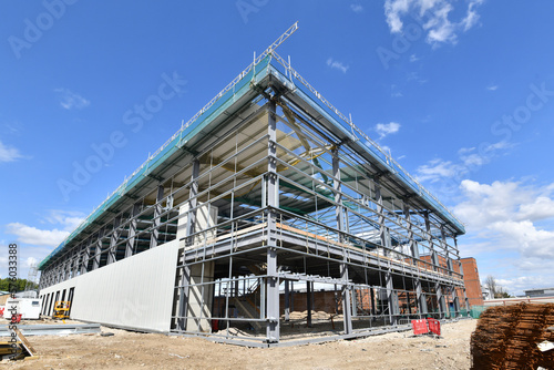 construction site of commercial warehouse building showing various materials and frame of building .