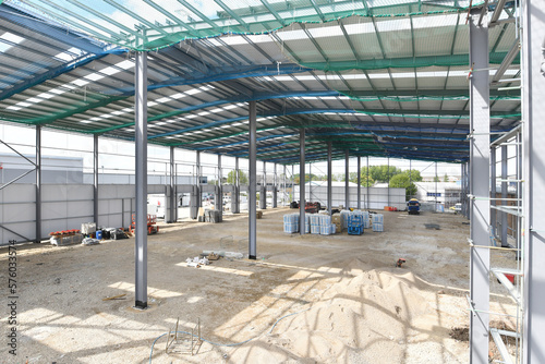 construction site of commercial warehouse building showing various materials and frame of building
