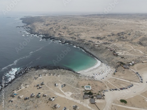 Playa la Virgen, Atacama/Chile- February, 02, 2023: White sand beach, turquoise water and surrounded by the Atacameño desert.