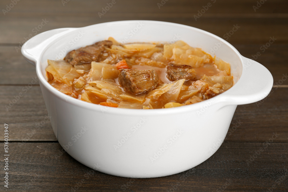 Tasty cabbage soup with meat and carrot on wooden table, closeup Tasty cabbage soup with meat and carrot on wooden table, closeup