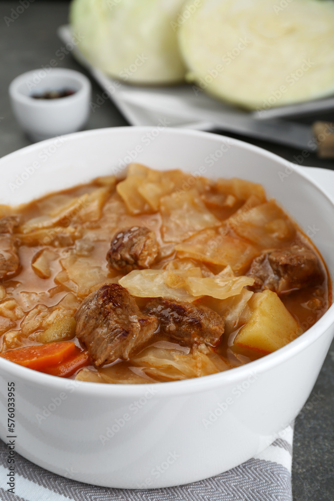Tasty cabbage soup with meat and carrot on grey table, closeup Tasty cabbage soup with meat and carrot on grey table, closeup