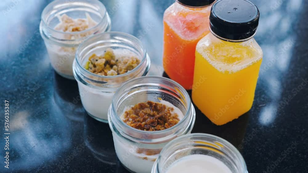 Two bottles of fresh squeezed juices and selection of different yogurt flavors Two bottles of fresh squeezed juices and selection of different yogurt flavors