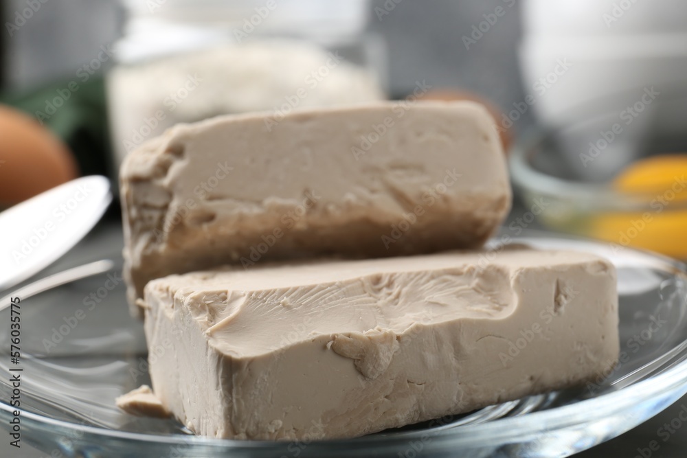 Fresh compressed yeast on grey table, closeup